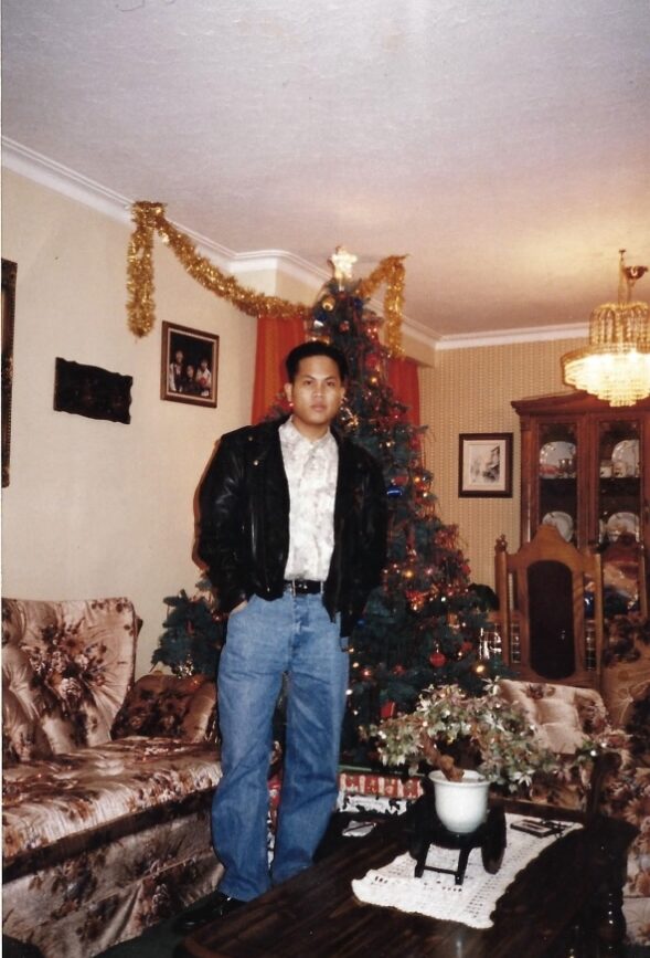 A man standing in front of a Christmas tree