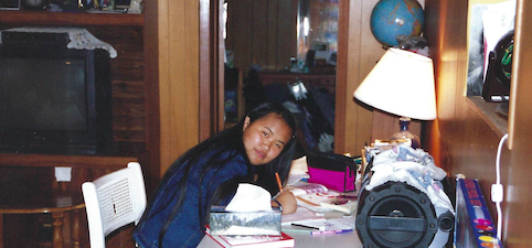 A girl doing homework at her desk.