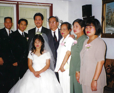 A bride sitting with her family around her