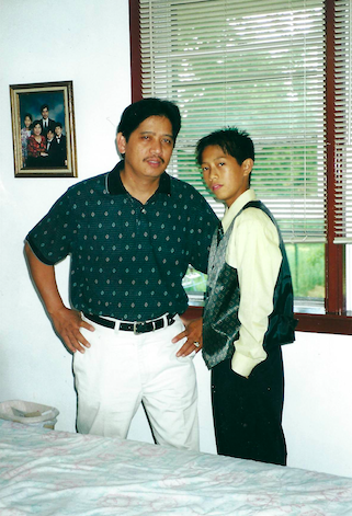 A man and his son posing for a photo