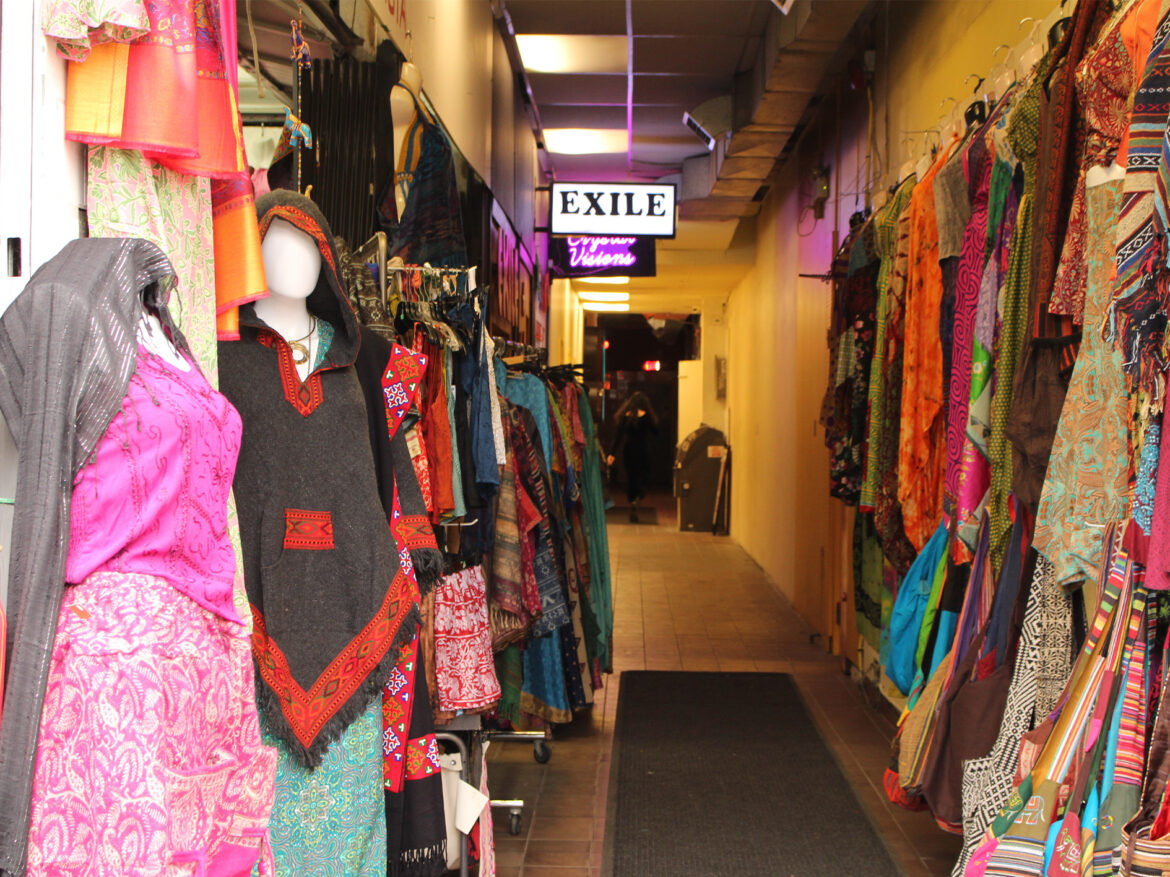 Exile sign is pictured along with racks of vintage clothing.