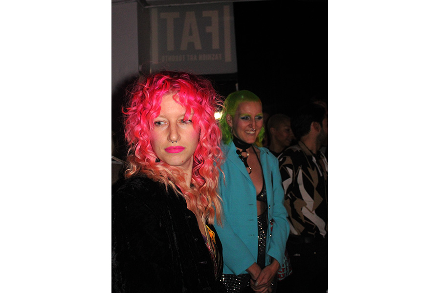 Fashion Art Toronto attendees are pictured with pink and green hair, left side attendee is pictured in black, with right subject in blue.